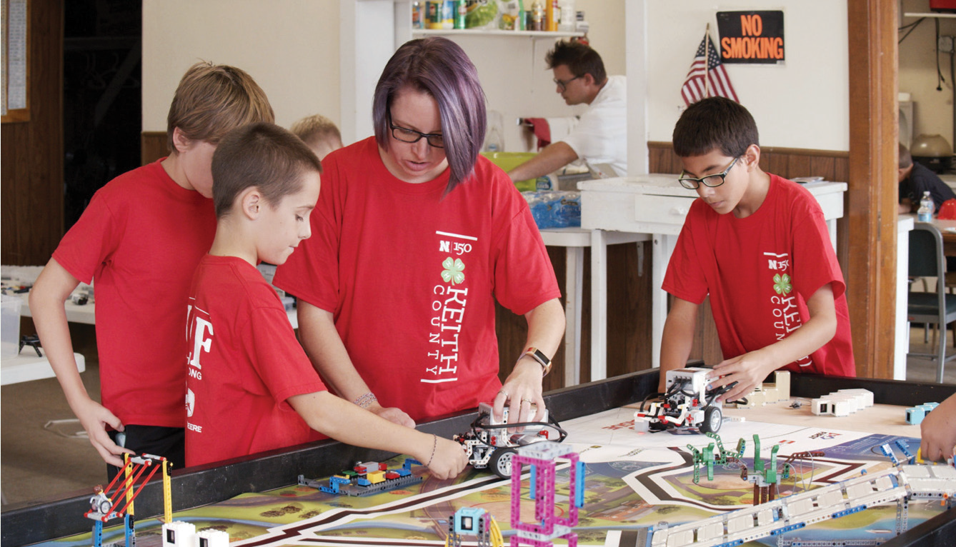 group of children working with educator building robots