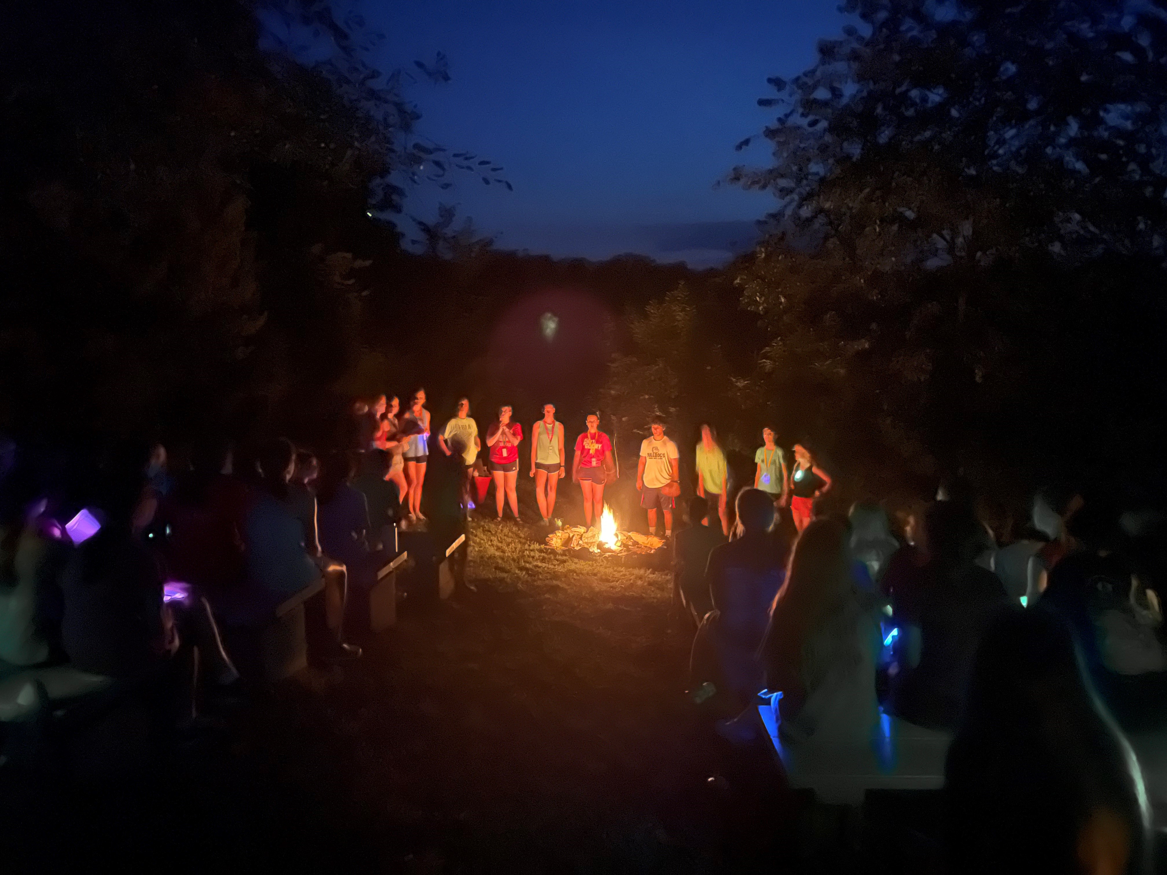 Campers gathered around a campfire
