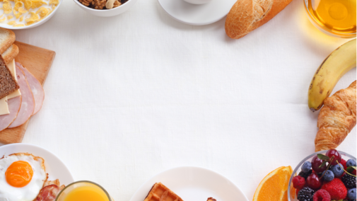 An array of breakfast items such as coffee, eggs, fruit and breads