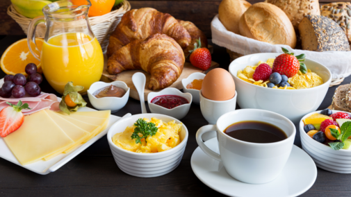 A variety of breakfast foods sit on a table