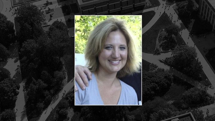 Color portrait of Jean Ann Fischer on a black campus background