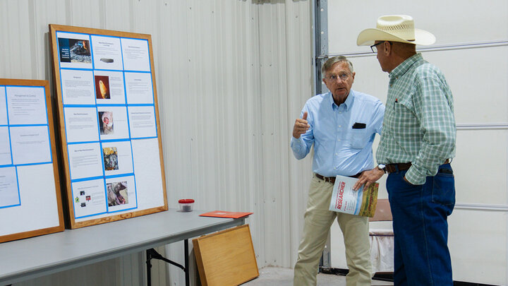 David Boxler (left) discusses fly control with a Nebraska rancher at the Gudmundsen Sandhills Laboratory Open House in Whitman, Neb.