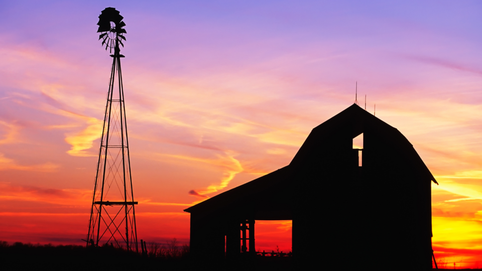 Barn and windmill with colorful sunset