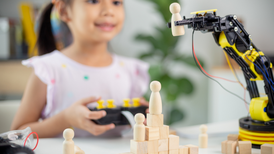 Girl operating a robot