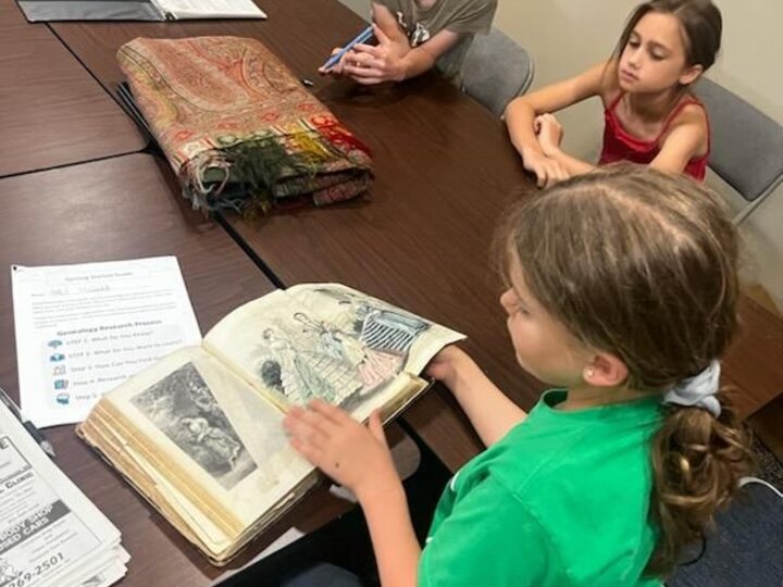 youth looking at artifacts