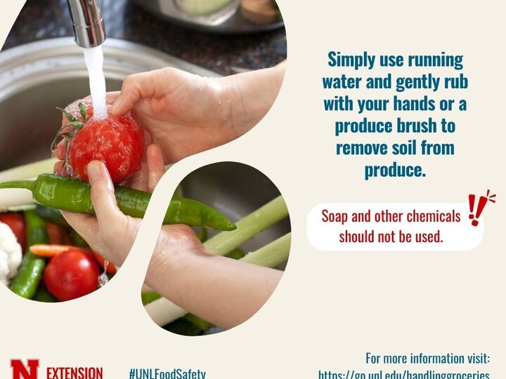 Hands rinsing produce under running water in a kitchen sink. Multicolored vegetables visible.