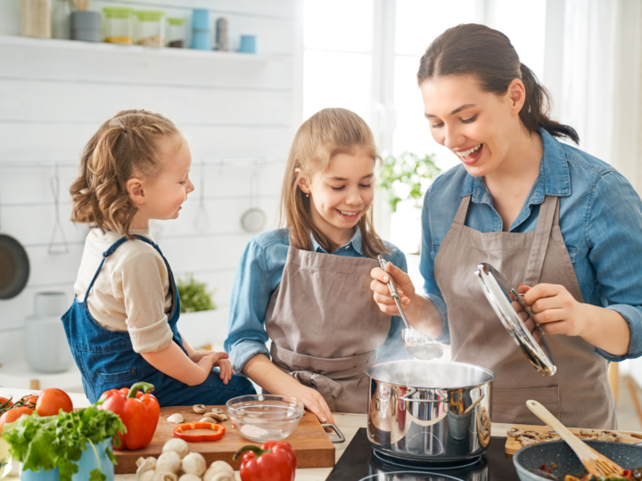 Mom cooking with her two daughters