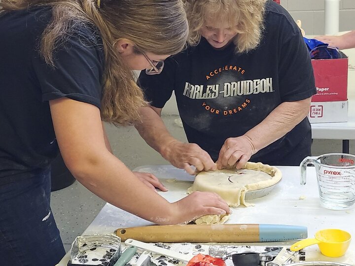 youth and adult making pie crust