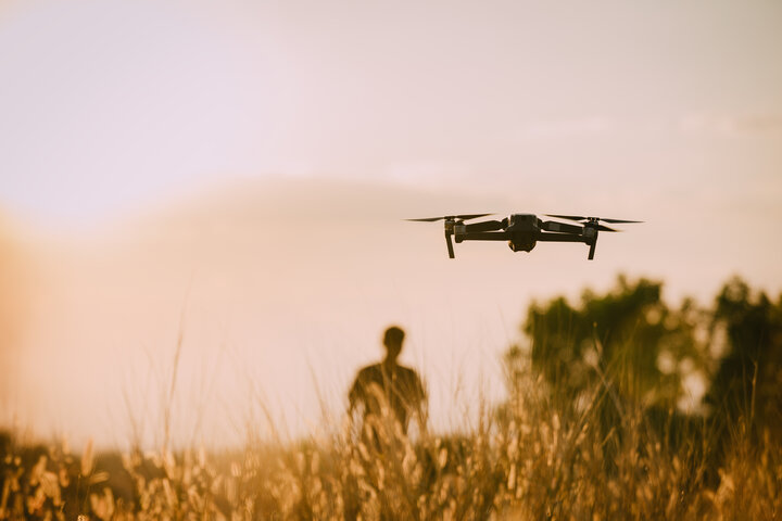 A man and his drone in a field