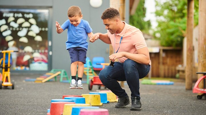 Adult playing with child in classroom