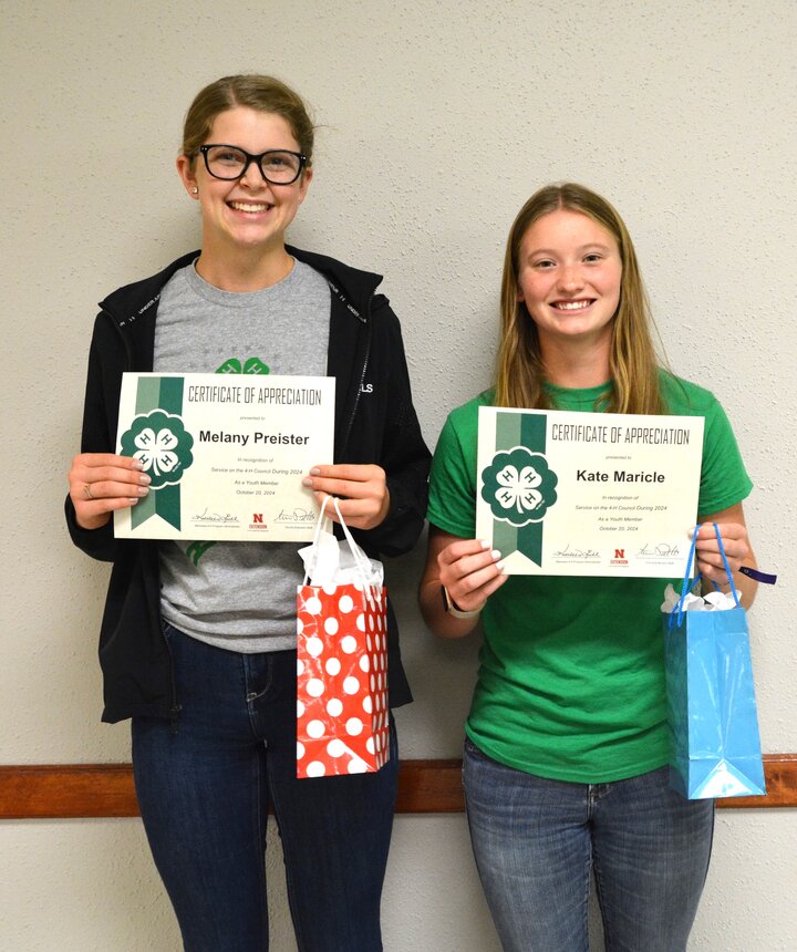 Two youth 4-H Council members with service awards