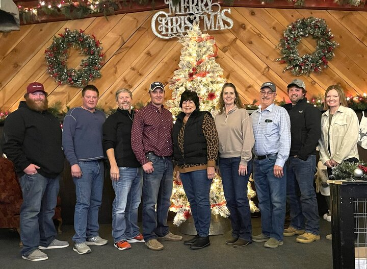 Extension Board members in front of Christmas Tree