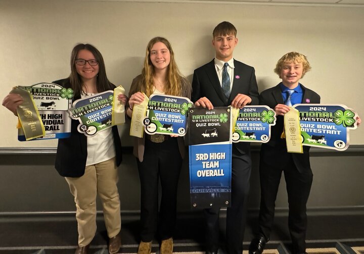 Four students with National 4-H Livestock Quiz Bowl ribbons