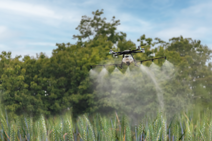 Drone spraying a field