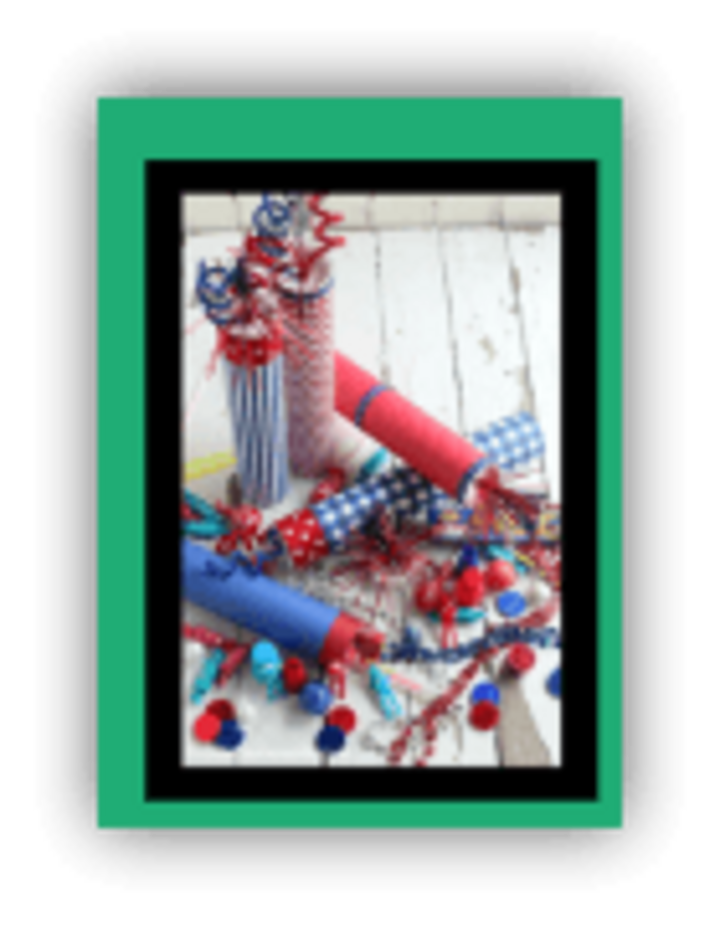 Colorful party poppers with ribbons, confetti, and pom-poms on a rustic white surface.