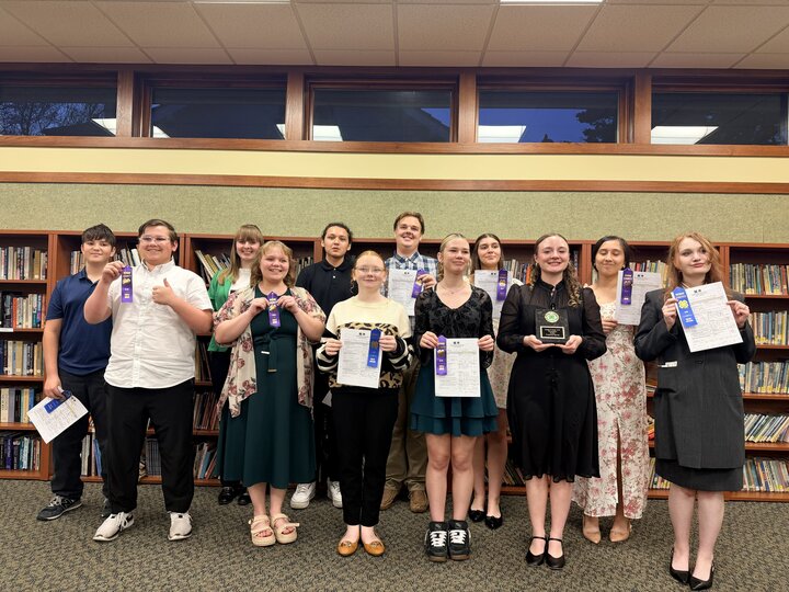 Senior Prepared Speech participants posing with awards and certificates in a library setting