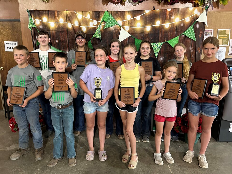 youth with trophies county fair